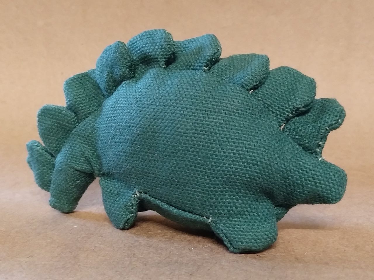 a small stegosaurus plushie