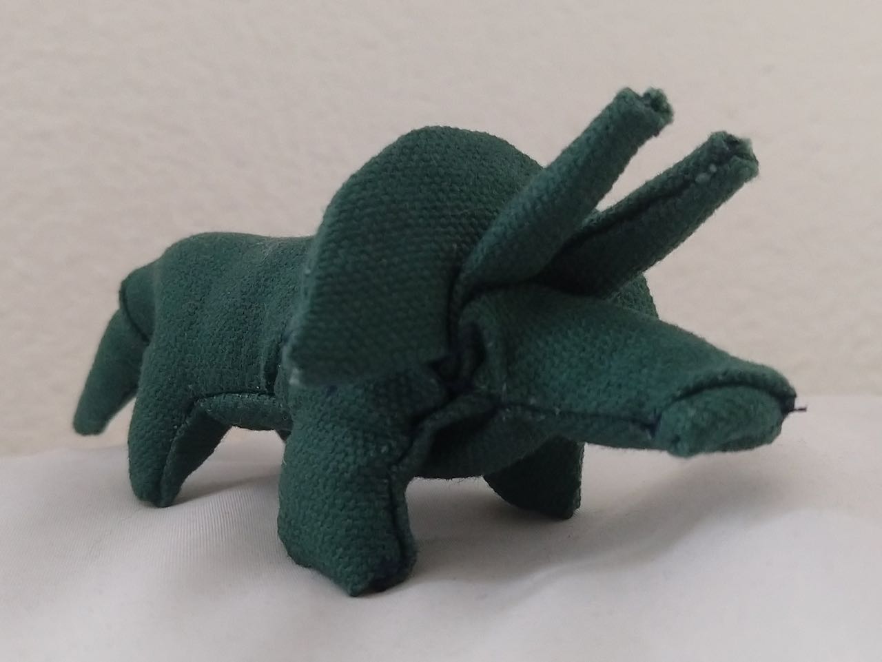 a small triceratops plushie